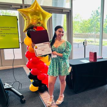 RESET Scholar holding certificate