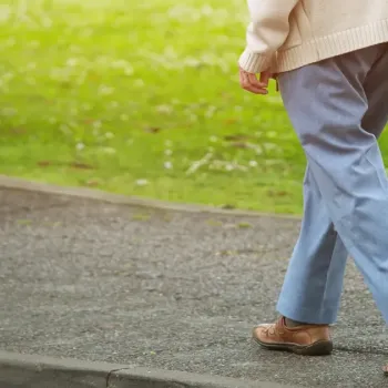 Person walking with cane 